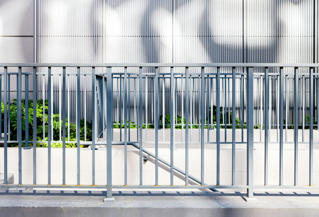 A gated area in front of a building with graffiti on it